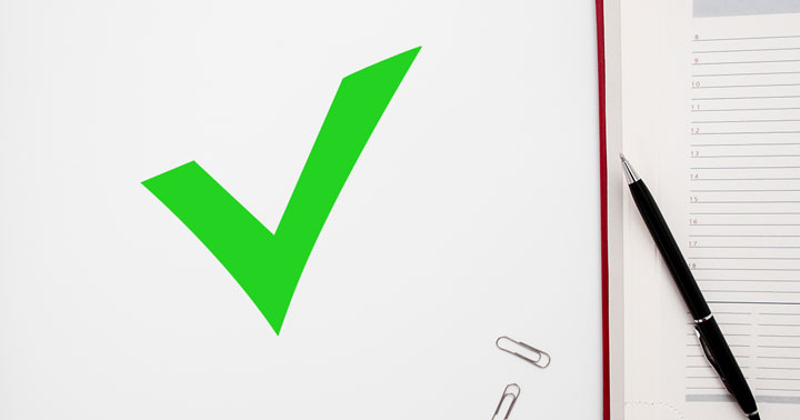 green checkmark with notebook